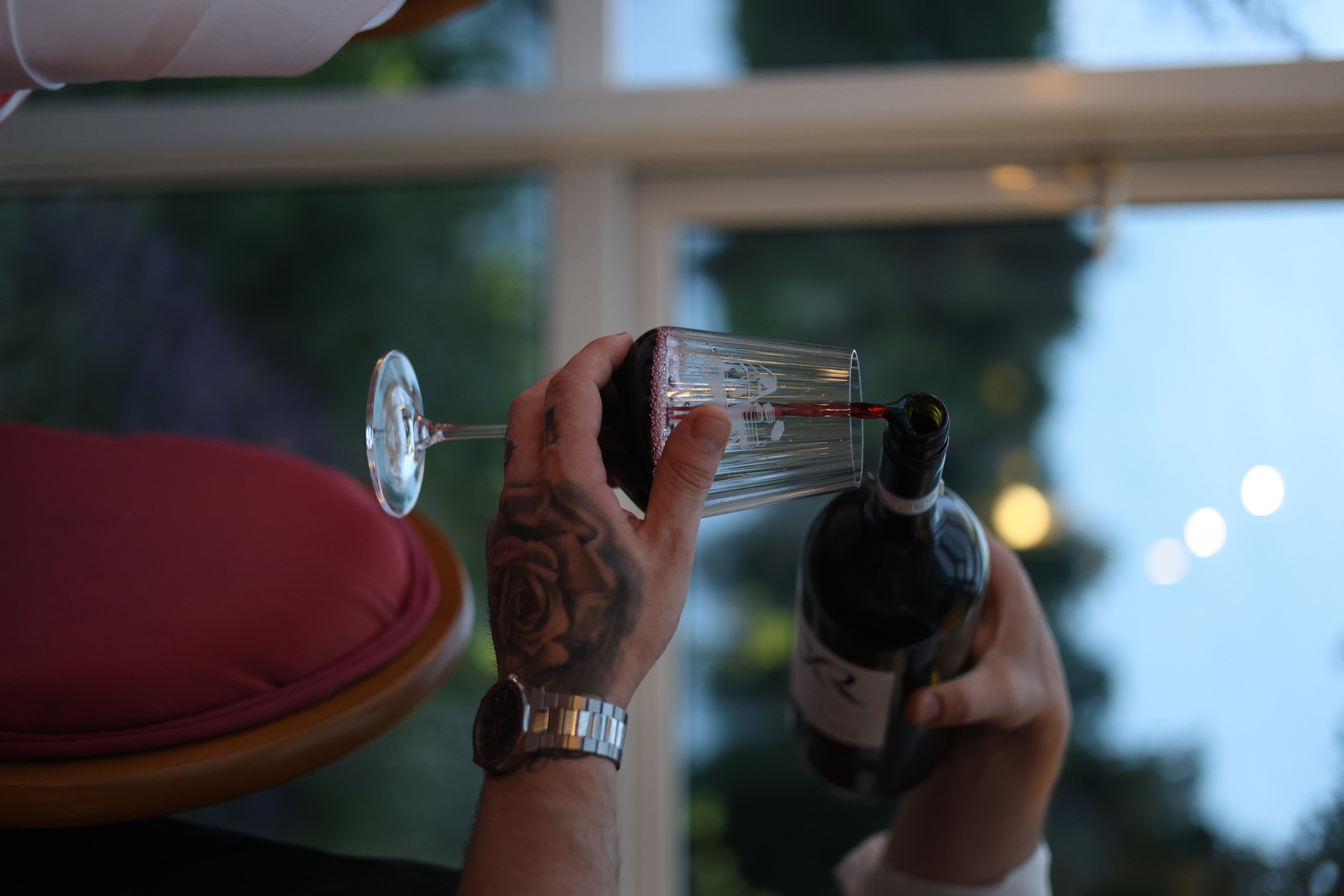 Red wine poured beside the lake-facing windows